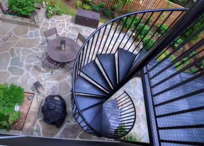Flagstone Patio and deck with spiral staircase by Classic Stonescaping & Gardens