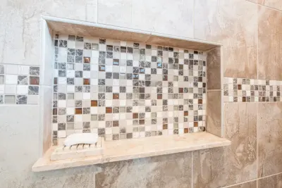 Mosaic Shower of Stone and Glass — Carpet Installation project by J&J Carpet One Floor & Home