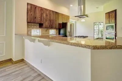Dark Stained Oak Kitchen and Entire House Flooring at Woodforest — Kitchen Remodeling project by Premium Residential Remodeling