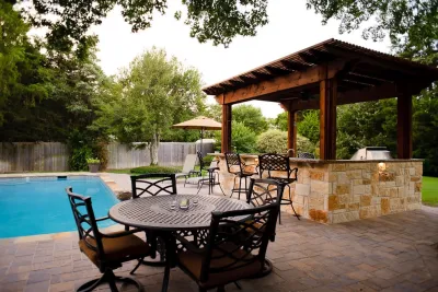 Outdoor Kitchen & Pergola with swimming pool remodel, Heath TX — Landscape Construction project by Dallas Outdoor Kitchens & Hardscape