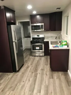 Brea, CA Kitchen Renovation Featuring Brown Cabinets and Grey Flooring — Home Renovation & Remodeling Services project by Capy Construction | Home & Kitchen Remodels + ADUs
