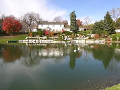 Historic Farmhouse Bank and Pond Landscape — Landscape Construction project by Hanselman Landscape And Gardens in Manheim