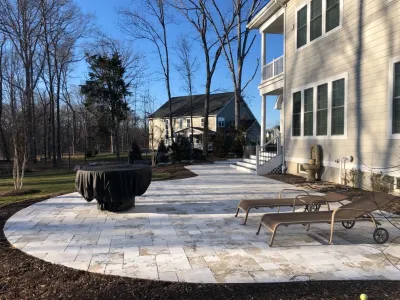 Travertine Patio, Boulder Fire Pit - Tynedale Court, Ashburn, VA by HEMAX Construction Services & Landscaping, LLC