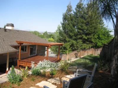 Terraced Backyard with Deck & Pergola by Hortus Design Sustainable Landscapes