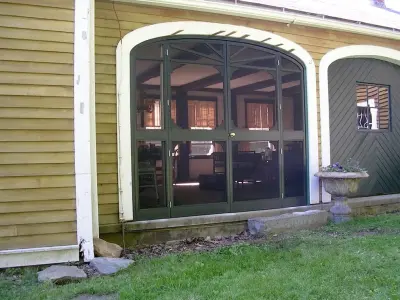 Curved screen doors for a barn extension by Butler Restorations LLC