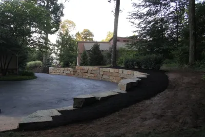 Boulder retaining wall — Landscape Construction project by Indian Run Landscaping II, LLC