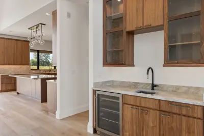 Wall-to-wall Walnut Slab by Signature Design & Cabinetry LLC