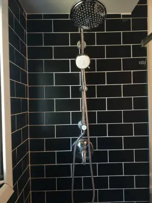 Renovation of Bathroom with Black Tiles — Countertop Installation Services project by Bonetti Tile