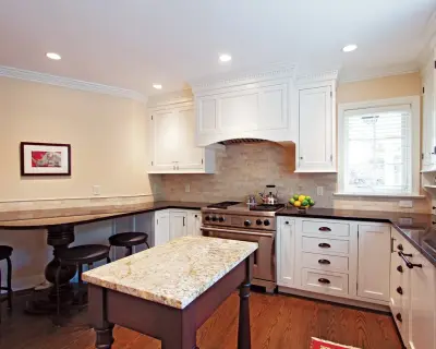 Classic Lakeside Residence with White Inset Kitchen Cabinets by Badger GraniteWerks, Inc.