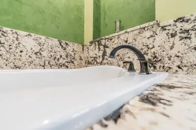 Elegant White Granite Bathroom Countertops — Countertop Installation Services project by East Coast Granite & Tile