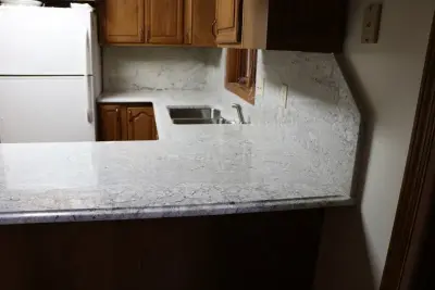 Antico Bianco Granite Kitchen Countertop with Complete Backsplash — Countertop Installation Services project by Gomez Granite Countertops