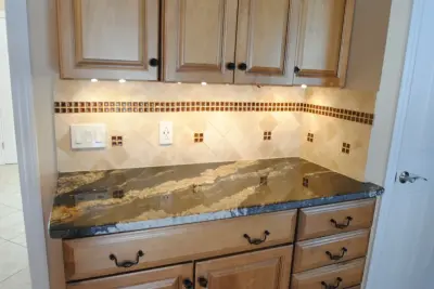 Natural Stone and Tantrum Glass Backsplash — Countertop Installation Services project by Tile Wholesalers