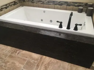 Natural tile bathtub surround and skirt by Sandia Marble