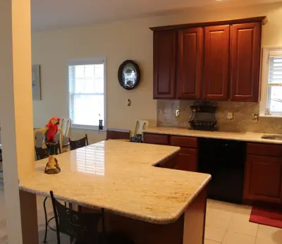 Classic Kitchen with L-Shaped Island and Granite Backsplash — Countertop Installation Services project by Merlino Marble And Granite