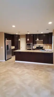 Travertine Flooring with Granite Countertops and Backsplash — Countertop Installation Services project by StartTile