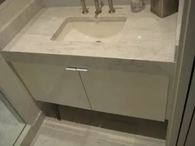 Mitered Apron Front Vanity: Carrera Marble — Countertop Installation Services project by LaBruyere Stone