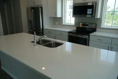 All-White Kitchen Featuring Coordinating Quartz Countertops — Countertop Installation Services project by Paradise Granite LLC