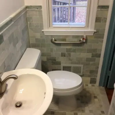 Marble-Tiled Compact Bathroom — Home Renovation & Remodeling Services project by Virginia Building And Remodeling