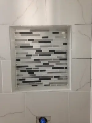 Compact Bathroom with Small Tiles — Home Renovation & Remodeling Services project by Renewed Dwellings