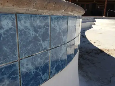 Pool Renovation: Plaster Repair, Tile Replacement, and Coping Installation — Home Renovation & Remodeling Services project by Big Horn Construction, LTD
