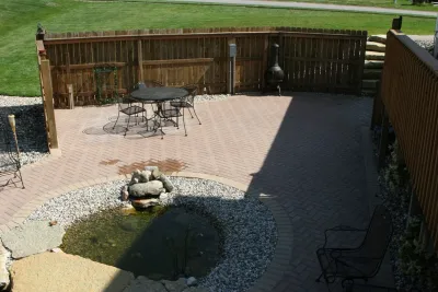 Backyard Patio and Pond — Landscape Construction project by Majestic Services Of Michigan in Rockford