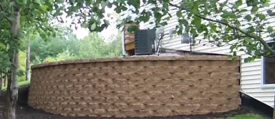 Retaining Wall with Boulders around Yard — Landscape Construction project by Majestic Services Of Michigan in Sparta