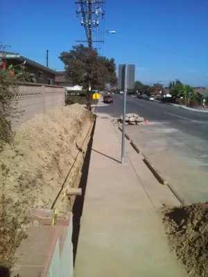 perimeter retaining wall with integrated steps and paver parking area — Landscape Construction project by Natur Landscape Creations in Los Angeles