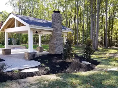 Outdoor Pavilion with Fireplace by Coastal Outdoor Spaces
