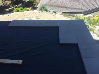 Glass-railed paver deck — Deck Building & Repair project by Dexperts