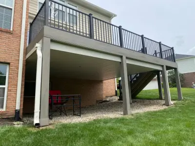 Tiered composite deck with metal railing by DeckThisOut