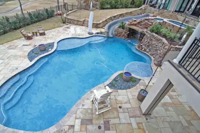 Lagoon Swimming Pool and Waterslide by Preferred Pools Inc.