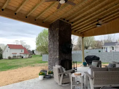 Patio with Fireplace and Shed Roof by Epoch Construction LLC