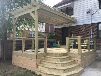 Pine Decking with Pergola, Wrap-Around Stairs, and Horizontal Steel Railing — Deck Building & Repair project by The Deck Pro