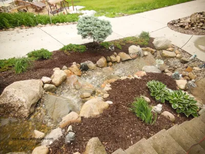 Brummitt Property Pondless Waterfall and landscaping with field stone by Premiere Aquascapes