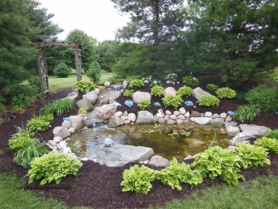 Bubacz Project, pondless waterfall, pond, landscaping, hydrangeas, field stone by Premiere Aquascapes