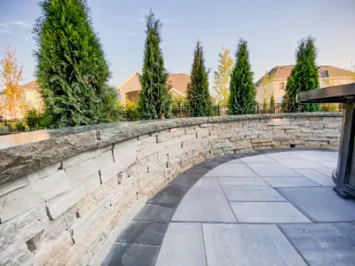 Outdoor Living Space with Pavilion, Patio, Kitchen, and Fire Pit by Kansas City Hardscapes