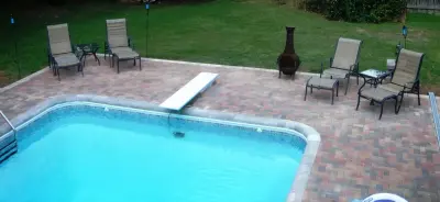 Warner Robins GA patio pavers, covered porch, outdoor cooking area, and fire pit — Deck Building & Repair project by Archadeck Of Central GA
