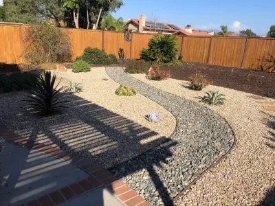 Gravel and River rock landscape by Quetzal Landscapes, Inc.