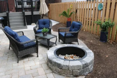 Urban Patio with Fire Pit, Fence & Rain Garden by Quiet Village Landscaping