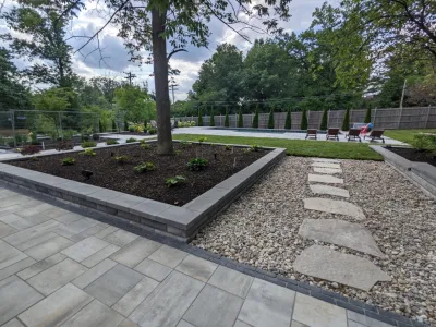Modern Poolside Entertaining Space with Outdoor Kitchen by Quiet Village Landscaping
