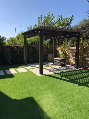 Low maintenance new back yard with concrete,synthetic grass,Pergula by RainforestLA,inc.