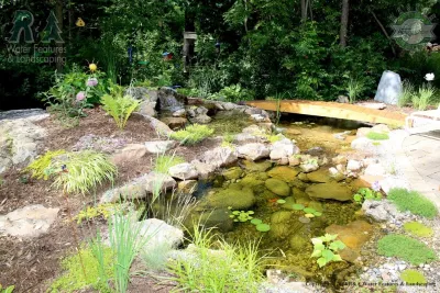 Kalamazoo Water Feature - Backyard Ponds with Bridge — Landscape Construction project by R&A Landscaping