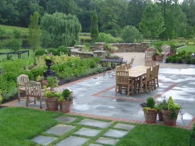 Large patio & pool with landscape design and plantings by Rock Water Farm