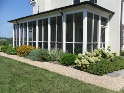 Beds around screened-in porch — Landscape Construction project by Rock Water Farm