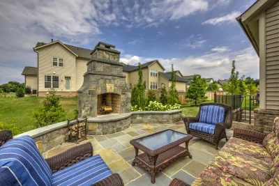 Backyard fireplace with classy curves. — Landscape Construction project by Rock Water Farm
