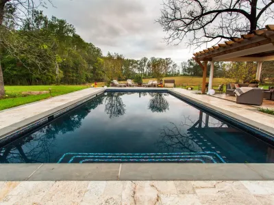 Swimming pool, pavilion and fireplace in Warrenton, VA. by Rock Water Farm