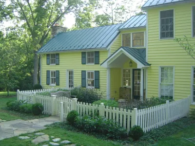 Fenced-in front yard with stone walkway and benches — Landscape Construction project by Rock Water Farm