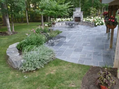 Lighted slate patio with fireplace - Ashburn, VA by Rock Water Farm