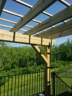 20x16 Composite Deck Featuring Custom Pergola and Black Aluminum Railings by Jaguar Decks And Fences