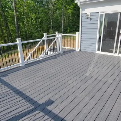 20x14 Composite Deck featuring PVC, Black Aluminum Railings, and Solar Lighting by Jaguar Decks And Fences